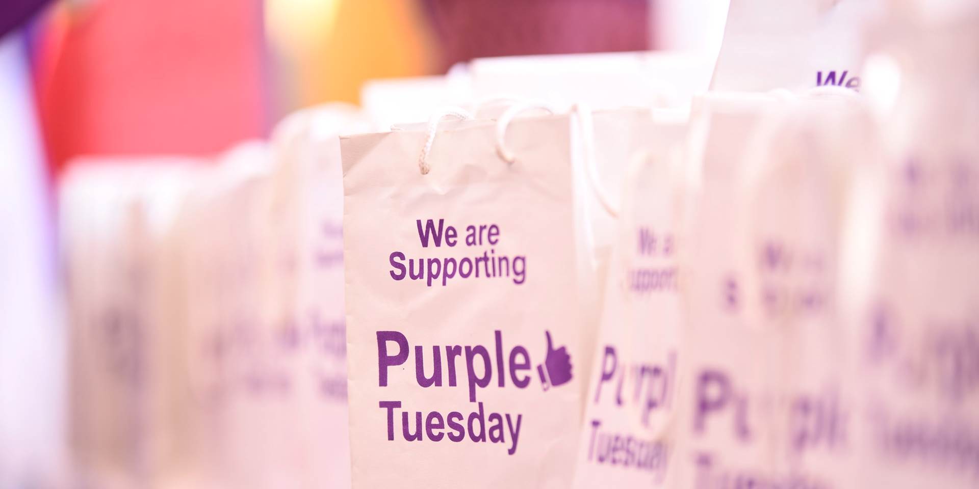 A picture of a bag with the Purple Tuesday logo on it