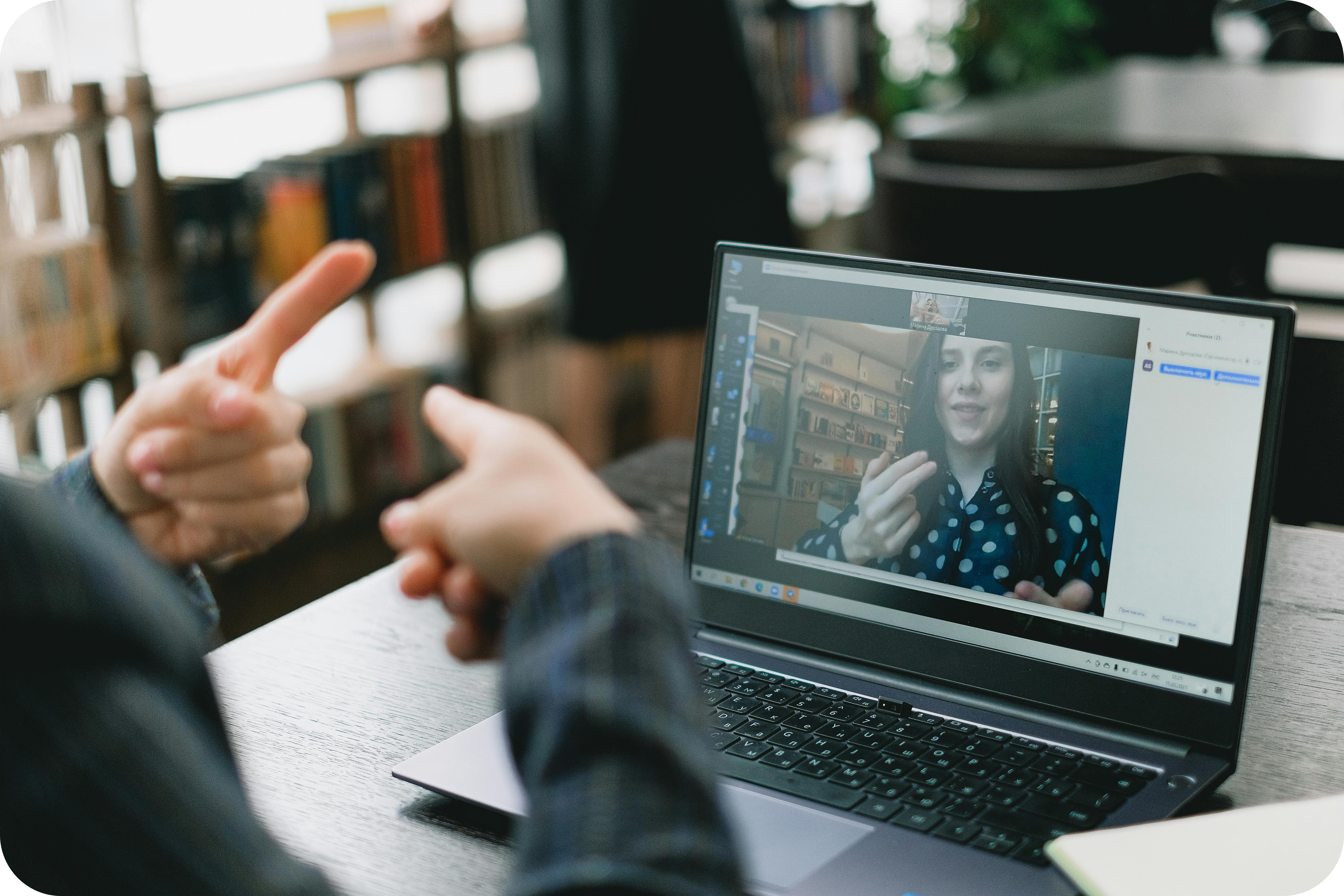 Two people on a virtual video call communicating in sign language